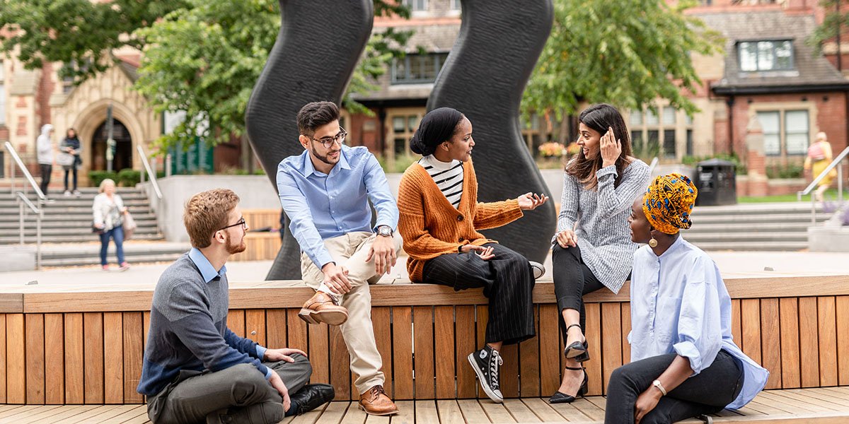 UoL international students on campus sat outside of School of Psychology