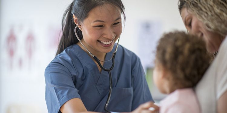 Healthcare professional assisting a child.
