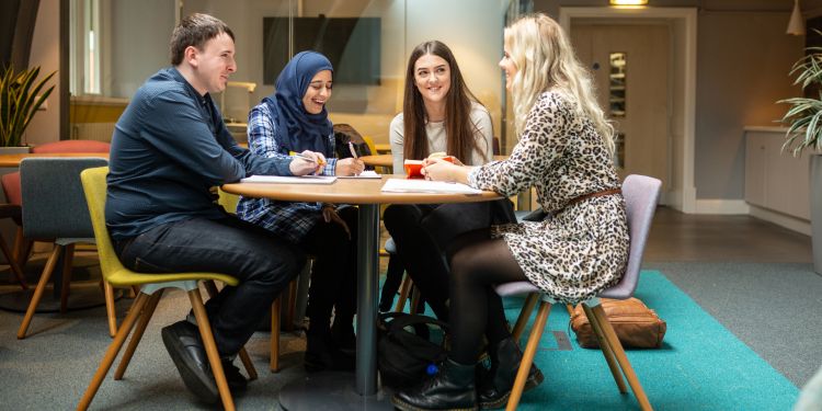 Group of mental health and social work work students sat studying in the Baines Wing at the University of Leeds.