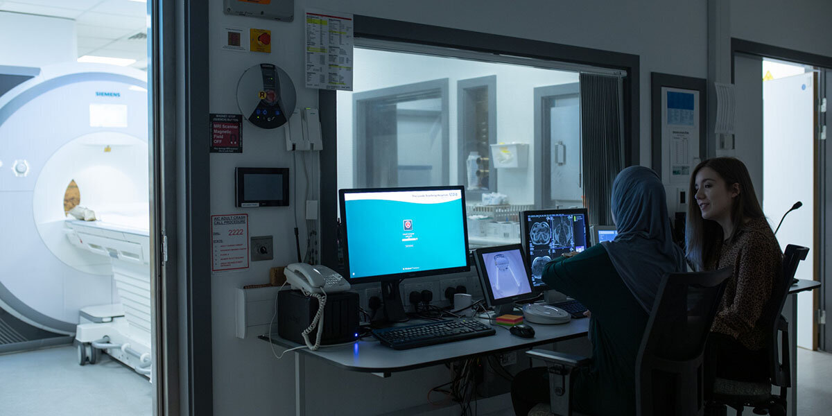 image of two students at MRI scanner