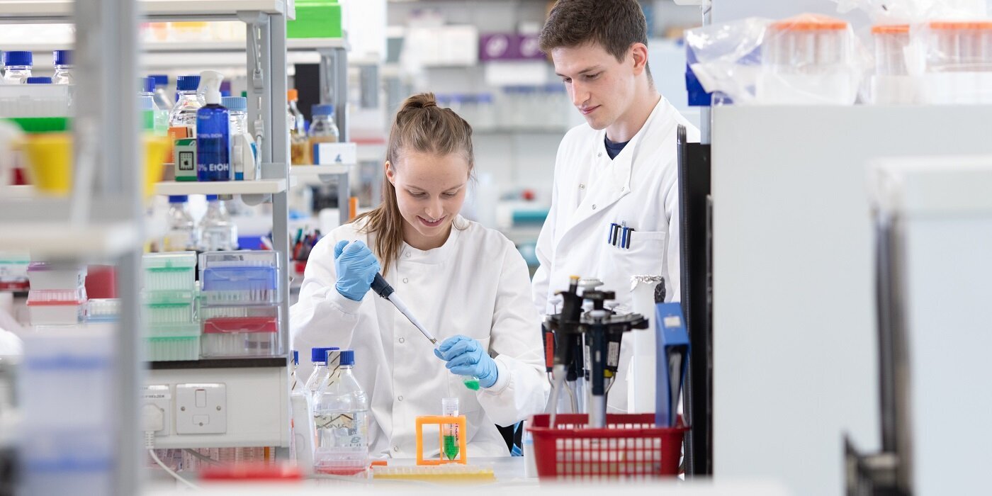 Two students working together in a lab.