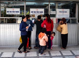 A family waiting at a hospital reception in Hanoi, Vietnam