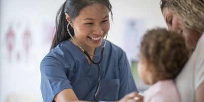 Healthcare professional assisting a child.