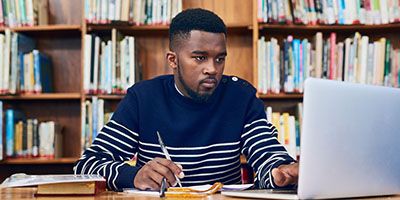 Student working on computer looking for research opportunities at the School of Psychology
