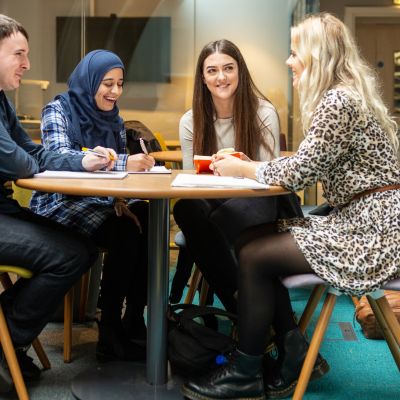 Group of mental health and social work work students sat studying in the Baines Wing at the University of Leeds.