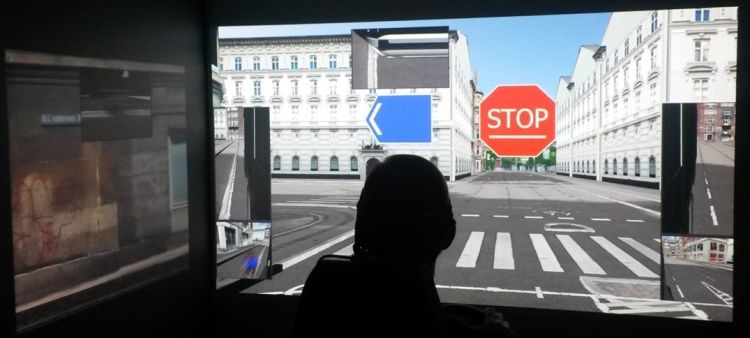 Student using fixed based L-shape cave driving simulator