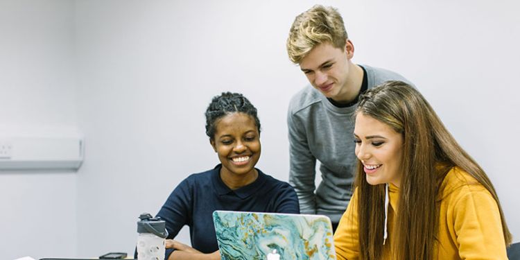 Group of students looking at a computer screen at the University of Leeds