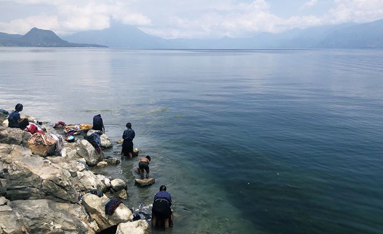 People washing their clothes in a lake