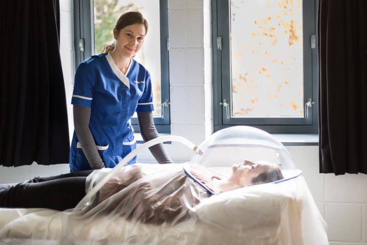 Healthcare professional using bioelectrical impedance for body composition technique