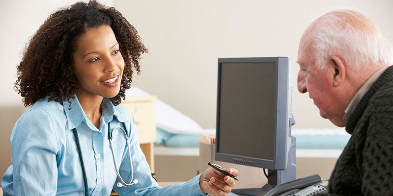 Doctor sitting at desk talking to patient